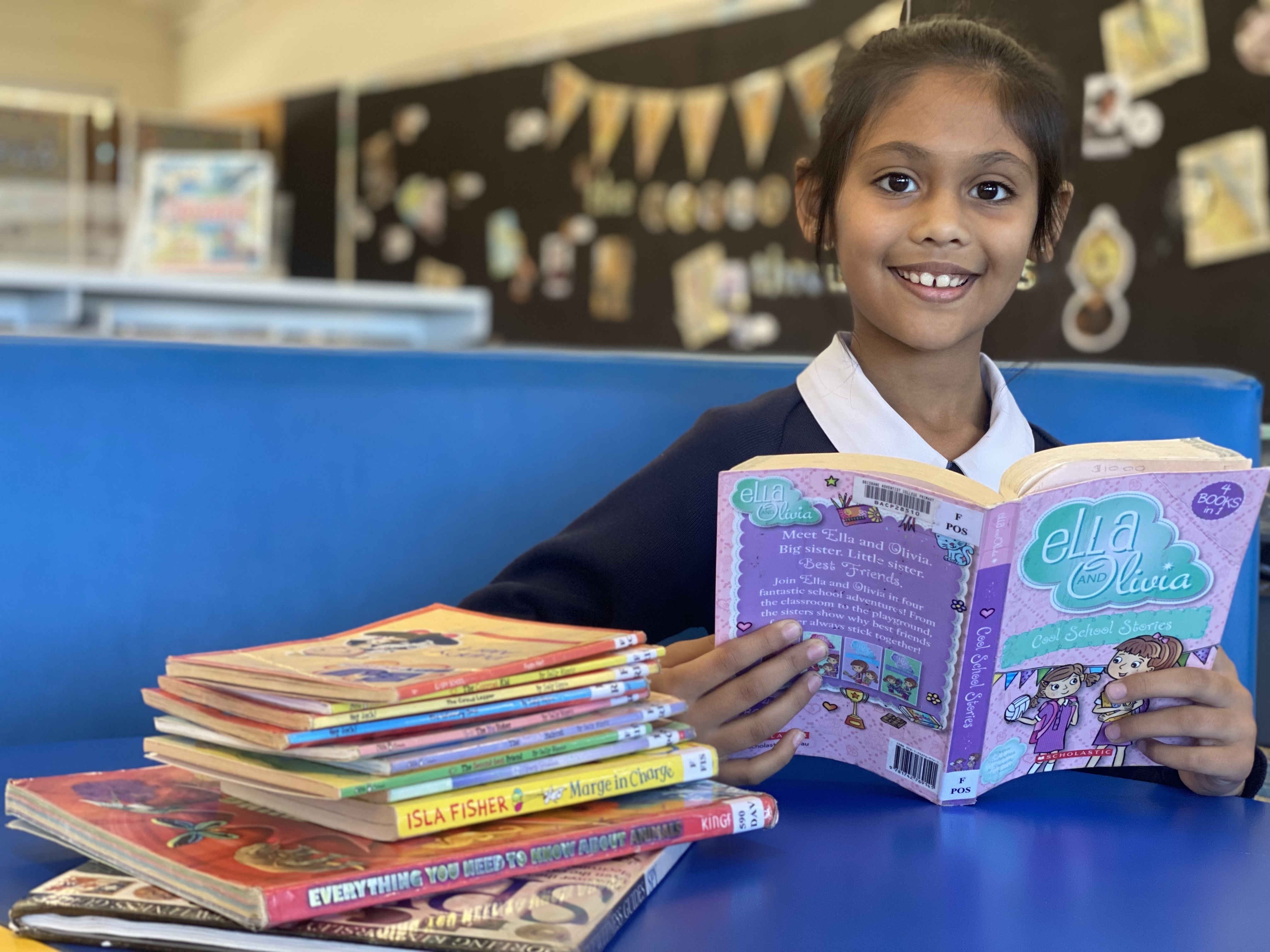 Abhisri with a pile of books
