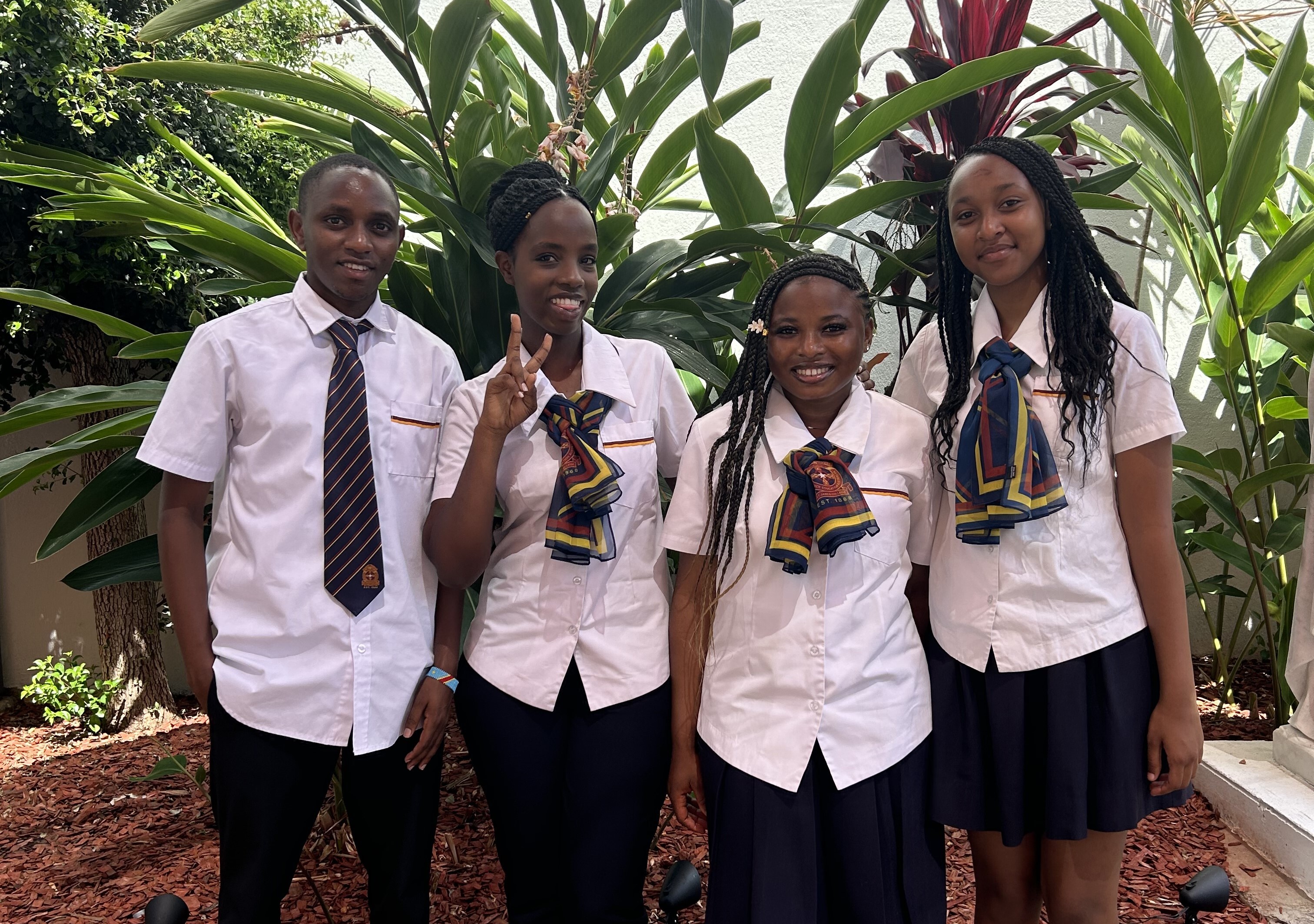 Students showcasing their graduation certificates